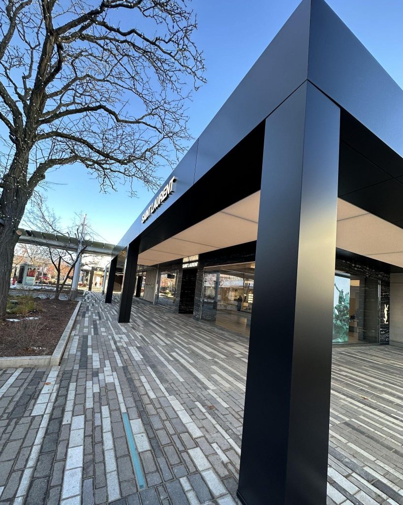 A large commercial building featuring modern gray metal wall panels.