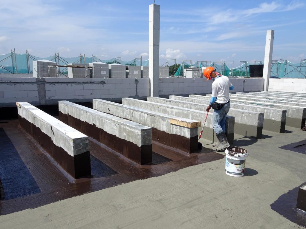 Experienced technicians practice roofing safety by wearing secure harnesses.